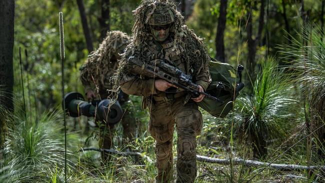 Soldiers from the 6th Battalion, Royal Australian Regiment move into position using camouflage and carrying their EF88 Austeyr rifles during a live-fire defence serial during exercise Diamond Walk at Shoalwater Bay, Queensland. Picture: Private Jacob Hilton