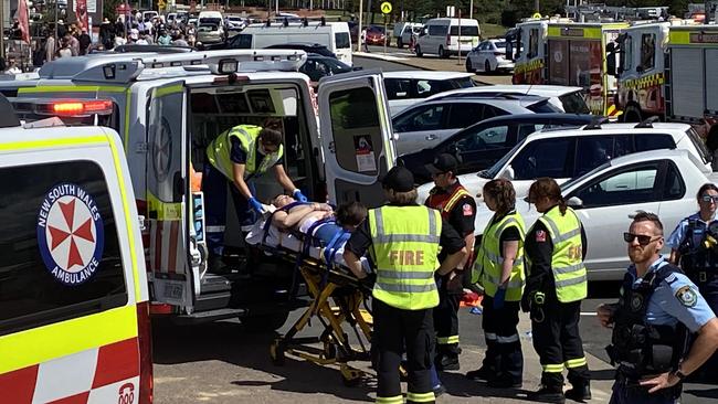 A person on a stretcher being put into an ambulance after a car plunged off a cliff at Bar Beach. Picture: Amy Ziniak