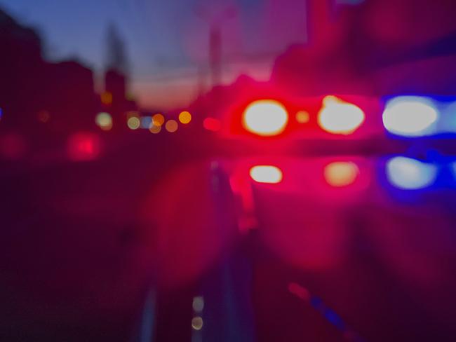 Red and blue Lights of police car in night time. Night patrolling the city. Abstract blurry image.