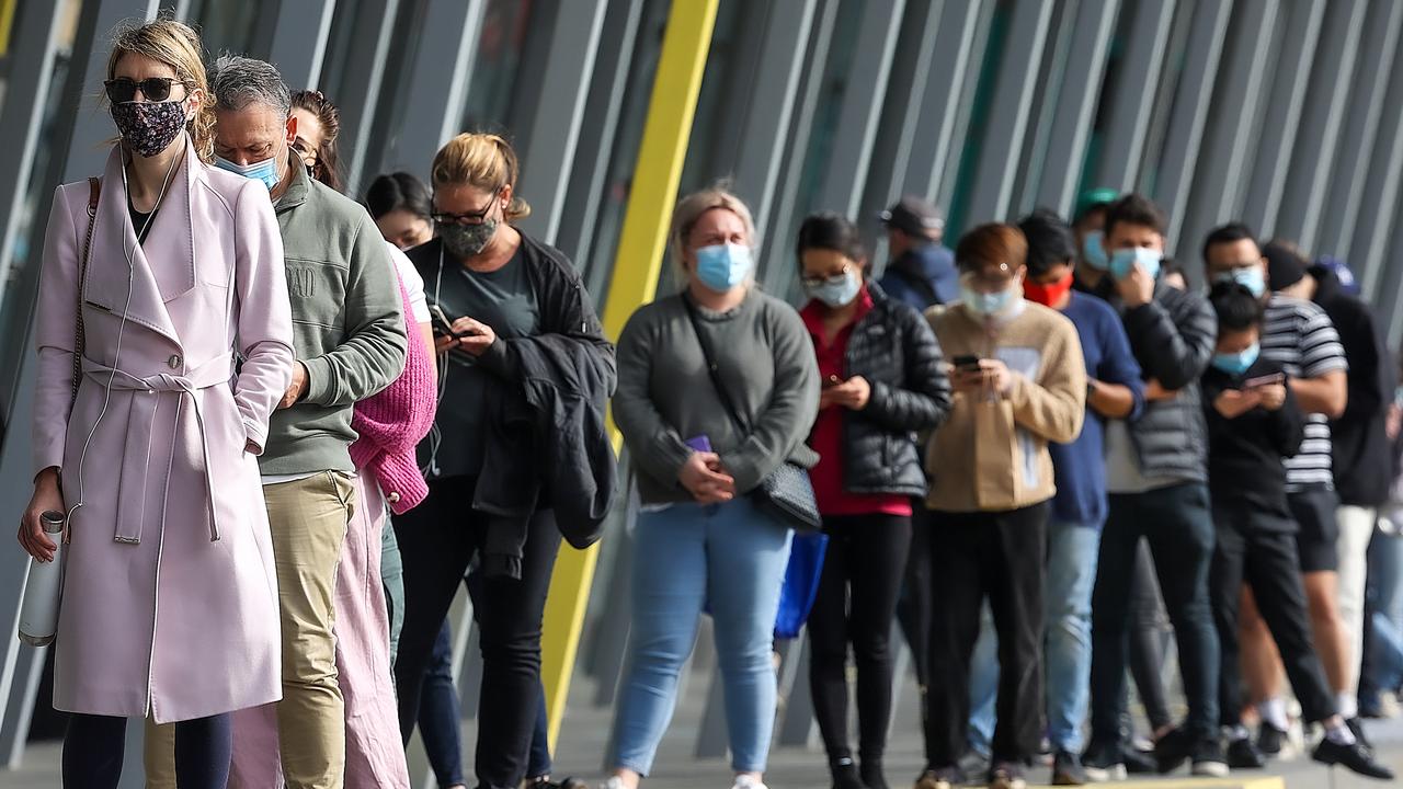 A long queue forms outside the Melbourne Convention Exhibition Centre. Picture: NCA NewsWire / Ian Currie