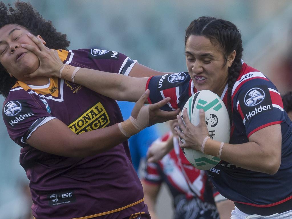 Julia Robinson of the Broncos (right) is tackled by Ruan Sims of the  Roosters during the