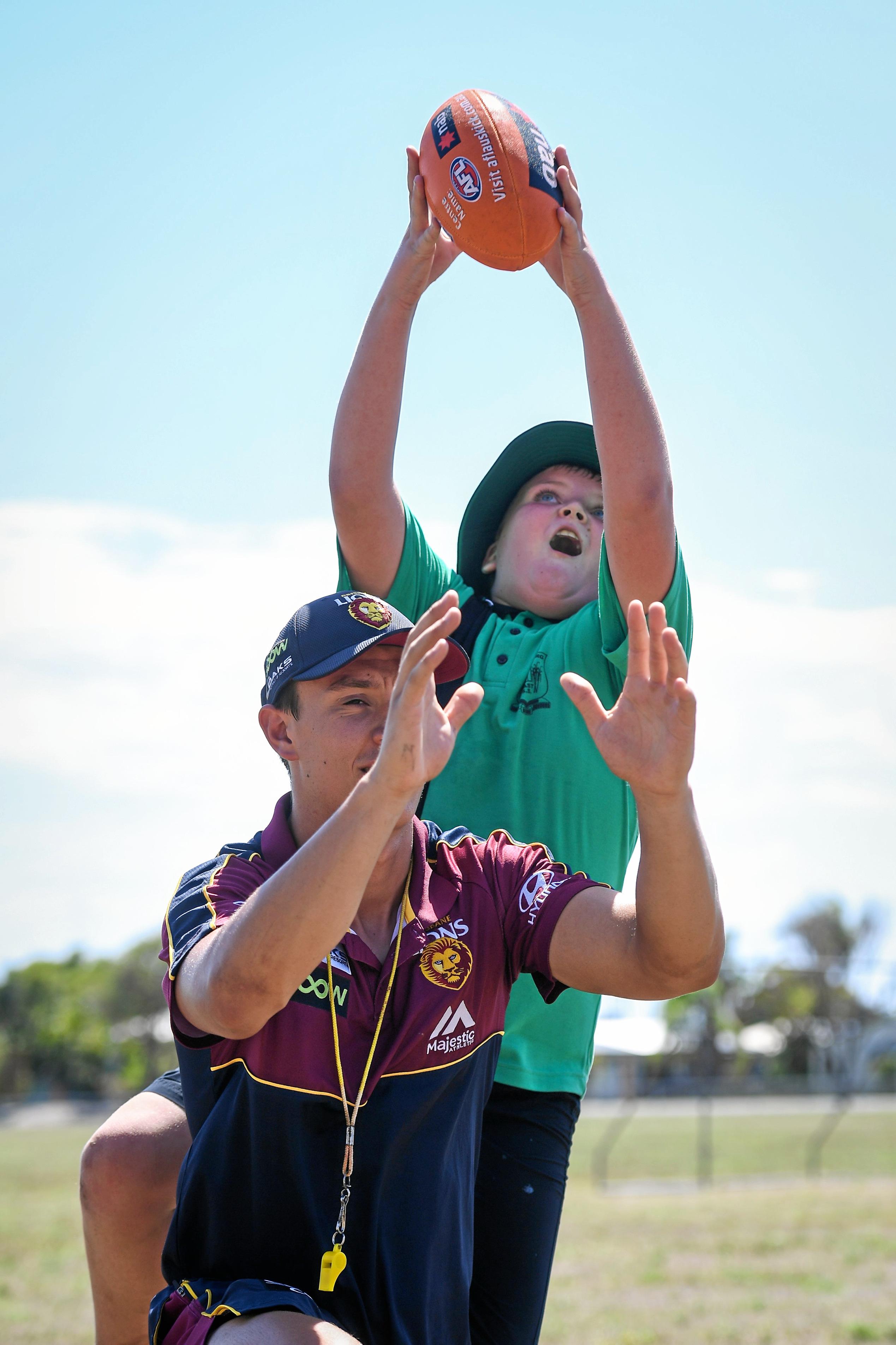 With eyes on the ball, Lochlan Rudd takes a screamer over the top of Lion, Hugh McCluggage. Picture: Brian Cassidy