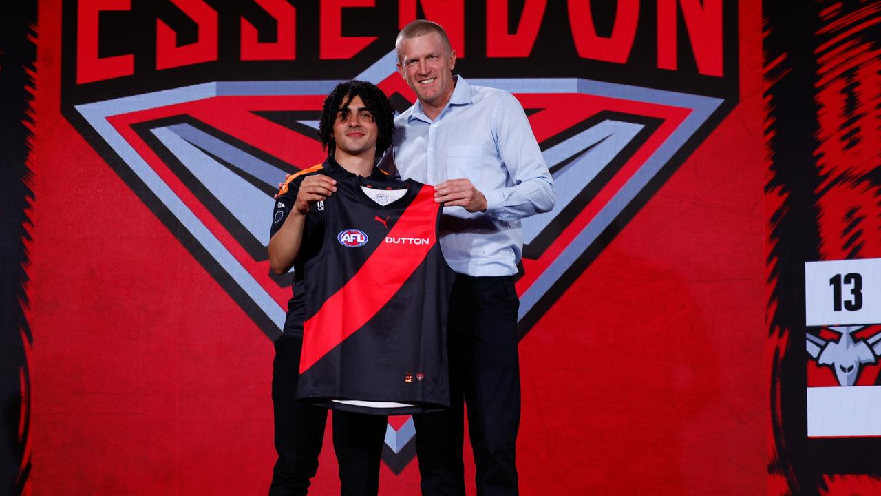 Isaac Kako receives his Essendon jumper on draft night. Picture: Michael Willson/AFL Photos via Getty Images