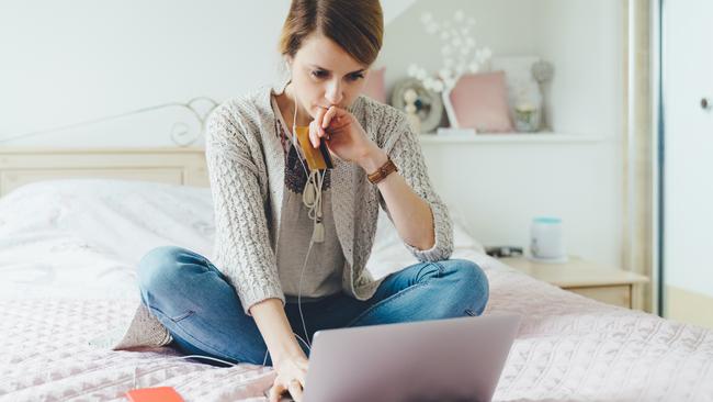 Coronavirus.  Picture: istock Young woman in the bedroom using laptop for planning the home finances