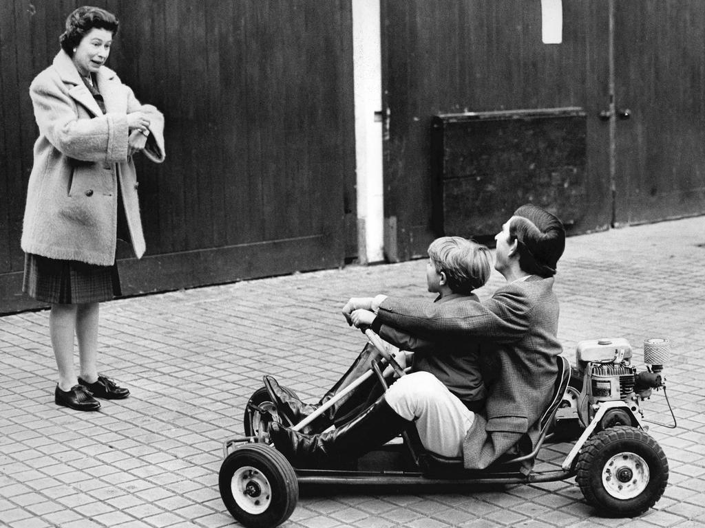 1969: Queen Elizabeth II talking with Prince Charles and Prince Edward riding on a go-kart at Windsor Castle. Picture: Central Press Photo Ltd/AFP