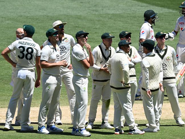 Australia’s fielders await the Third Umpire decision on the MCG big screen after a DRS challenge. Picture: Quinn Rooney/Getty Images