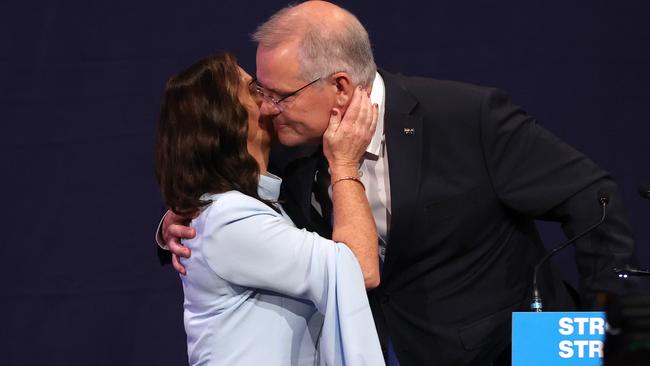 Jenny Morrison kisses Scott Morrison as he concedes defeat on Saturday night. Picture: NIGEL HALLETT