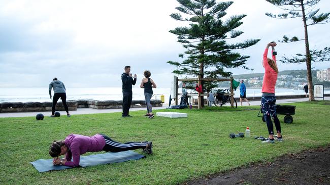 People participate in an outdoor bootcamp session hosted by Manly Beach Health Club at Manly Beach on May 15, 2020 as restrictions ease. Picture: Cameron Spencer.