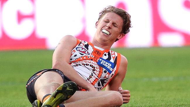 Lachie Whitfield was in agony after copping a hard hit against Gold Coast. Picture: Phil Hillyard.