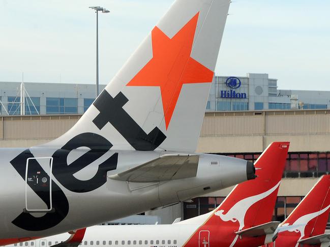 Jetstar Airways Pty and Qantas Airways Ltd. airplanes are parked at Melbourne Airport, in Melbourne, Australia, on Friday, Sept. 11, 2009. Qantas Airways Ltd., Australia's biggest airline, may sell its stake in Fiji's Air Pacific as it negotiates to add flights by its Jetstar discount carrier to the South Pacific nation. Photographer: Carla Gottgens/Bloomberg