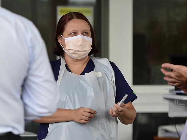 Thuringowa MP Aaron Harper and Townsville Hospital and Health Service Chief Executive Kieran Keyes are shown a swab sample. A mobile, drive through Coronavirus testing clinic has been established at Kirwan Health Campus, Townsville. PICTURE: MATT TAYLOR.