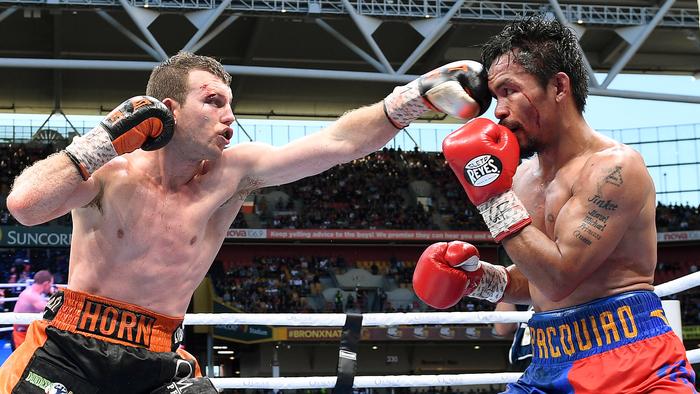 Manny Pacquiao of the Phillipines (right) is struck Jeff Horn of Australia down during the WBO World Welterweight Title fight at Suncorp Stadium in Brisbane, Sunday, July 2, 2017. (AAP Image/Dave Hunt) NO ARCHIVING, EDITORIAL USE ONLY