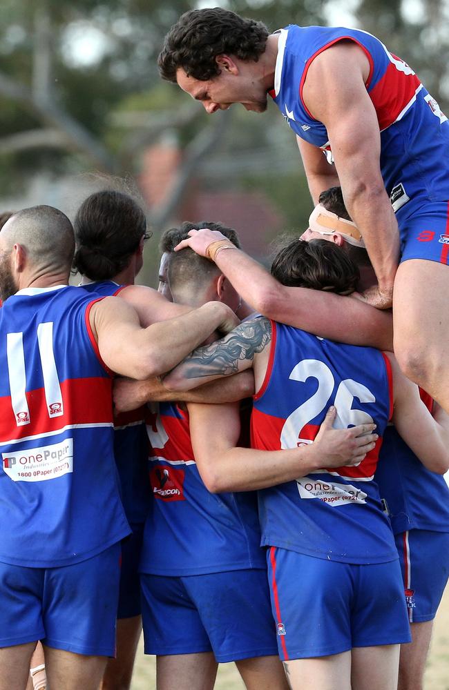 The Doggies pile on after the final siren.