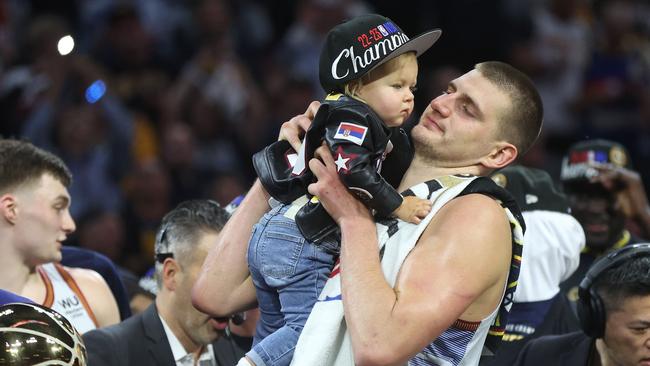 Nikola Jokic celebrates with his daughter Ognjena. Photo by MATTHEW STOCKMAN / GETTY IMAGES NORTH AMERICA / Getty Images via AFP.