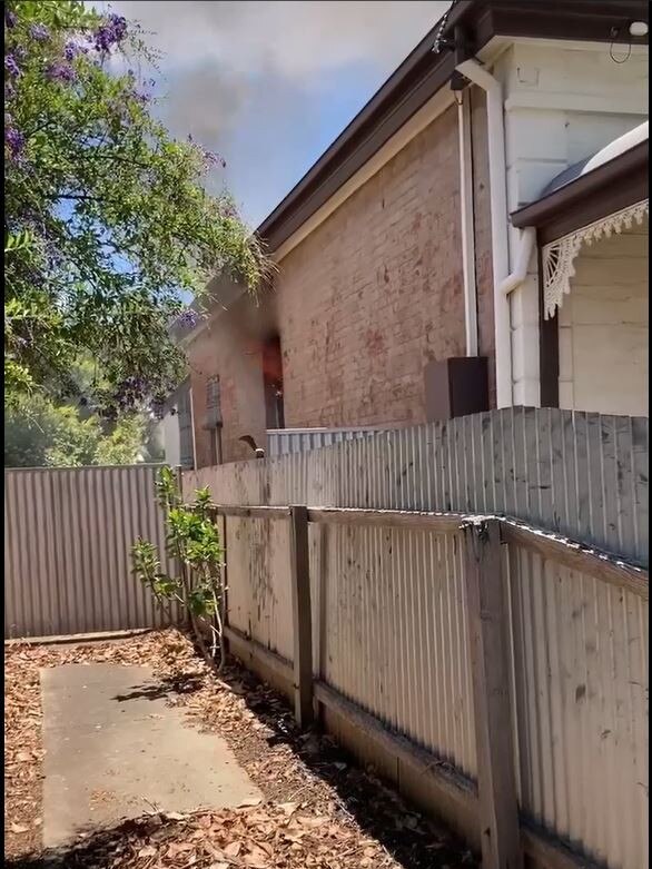 Flames could be seen from one of the rooms along with smoke billowing from the front yard. Picture: Dasha Havrilenko.