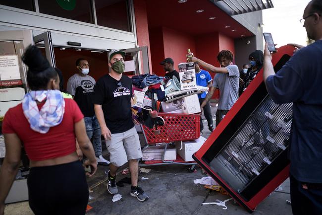 People leave a Target store with merchandise in Minneapolis. Picture: AP