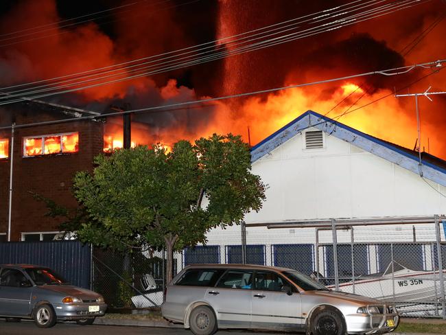 Fire has destroyed a storage complex on Burrows Road, Alexandria. Flames were seen rising 30 metres into the air with explosions heard coming from within. Photo: Bill Hearne