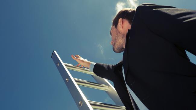 Businessman climbing the Ladder of success with blue sky background and copy space. Cross processedFor LIFE story