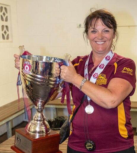 PBC AFC President Anne Cornish with the 2018 QAFL premiership cup. Picture supplied.