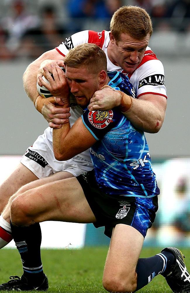 Sam Tomkins of the Warriors is tackled by Ben Creagh of the Dragons.