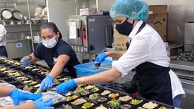 The Duchess of Sussex and Prince Harry have volunteered alongside ex-gang members at a Los Angeles bakery that provides food to vulnerable seniors and youths. Picture: Twitter Credit: The Duke and Duchess of Sussex