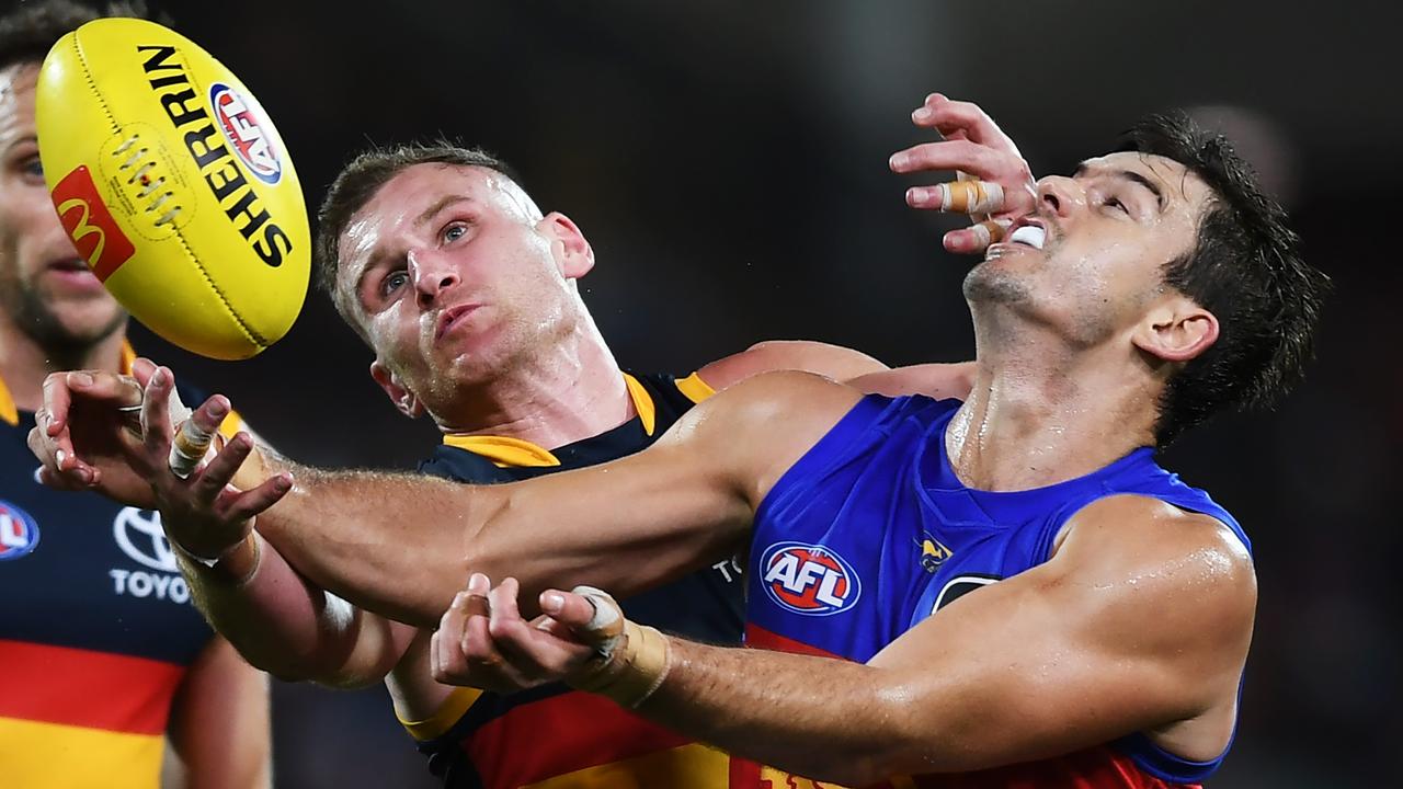 Rory Laird of the Crows competes with Jarryd Lyons of the Lions. Photo by Mark Brake/Getty Images