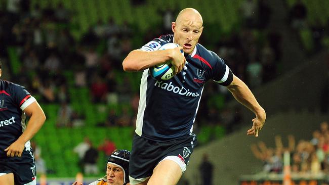 Super Rugby. Melbourne Rebels v Canberra Brumbies. AAMI Stadium. Stirling Mortlock breaks a Matt Giteau tackle to score the Rebels first try