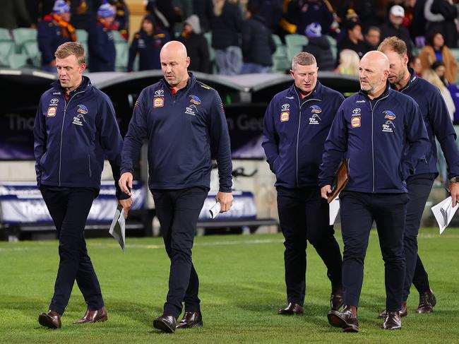 Matthew Nicks and his coaching group walk off Adelaide Oval on Thursday night. Picture: Sarah Reed/AFL Photos