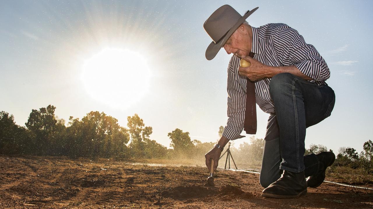 Kennedy MP Bob Katter plants a potato at Doomadgee using an ice cream scoop as his shovel. Picture: Brian Cassey