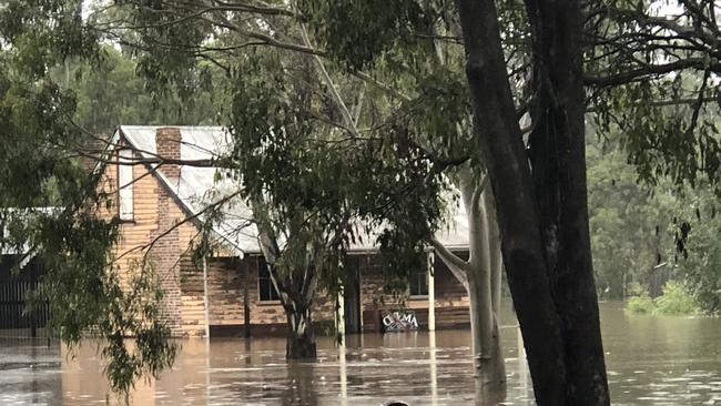 One of the historic homes surrounded by floodwaters. Picture: Helen Scotland