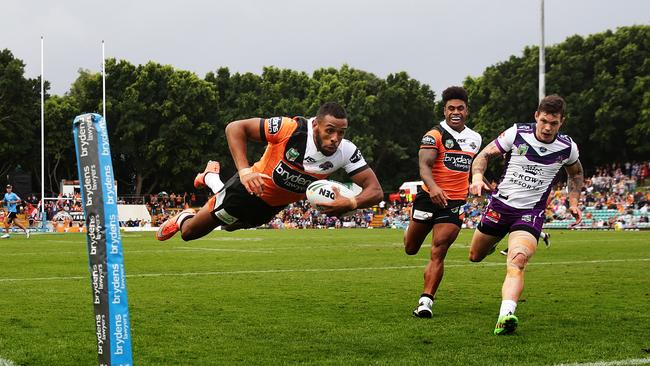 Josh Addo-Carr flies through the air to score for Wests Tigers.