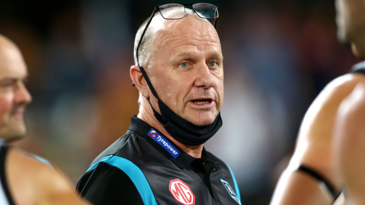 BRISBANE, AUSTRALIA - MARCH 19: Power coach Ken Hinkley talks to his team during the round one AFL match between the Brisbane Lions and the Port Adelaide Power at The Gabba on March 19, 2022 in Brisbane, Australia. (Photo by Jono Searle/AFL Photos/via Getty Images )