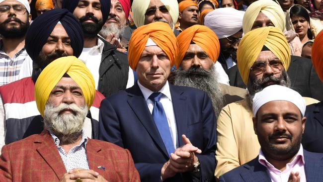 Former prime minister Tony Abbott pays his respect at the Golden Temple in Amritsar.