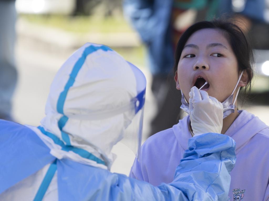 A girl sits for a Covid-19 test in Shanghai, China. Picture: Getty Images/Getty Images