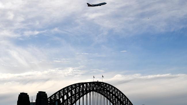 The last Qantas 747 airliner flies over the Sydney Harbour Bridge during its farewell flight on July 22. Picture: AFP