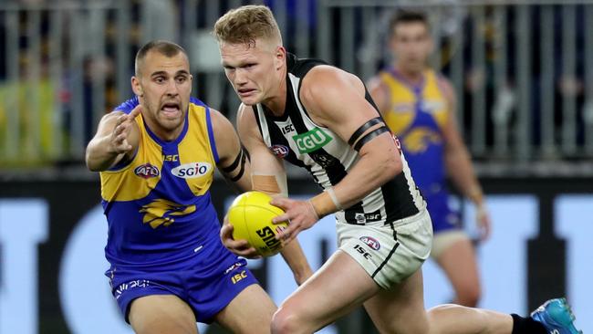 Adam Treloar gets away from Dom Sheed.