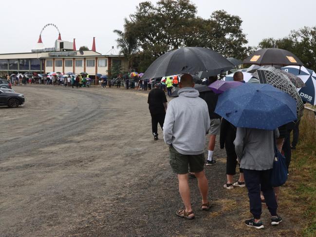 A long queue of people wait for their Covid jab at the Rocklea Showgrounds vaccination hub. Picture: David Clark