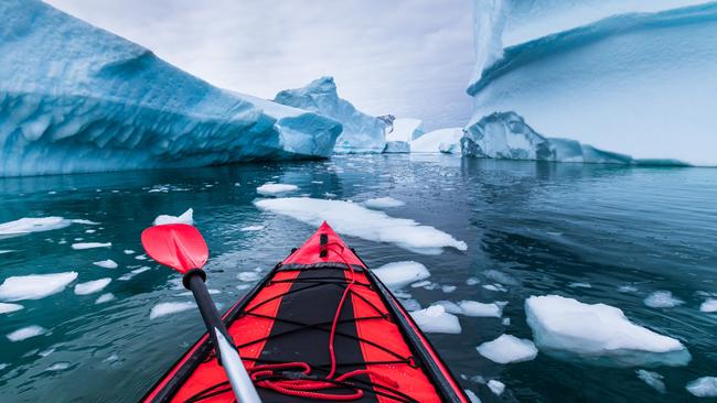 Kayaking between icebergs in the Antarctic.