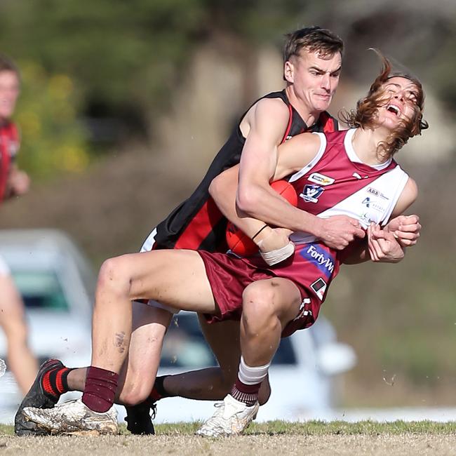 Hudson Holmes playing for Maffra last year tackles a Traralgon opponent. Picture: Yuri Kouzmin