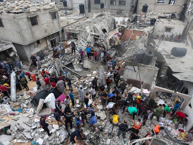 People search through buildings that were destroyed during Israeli air raids in the southern Gaza Strip. Picture: Getty Images