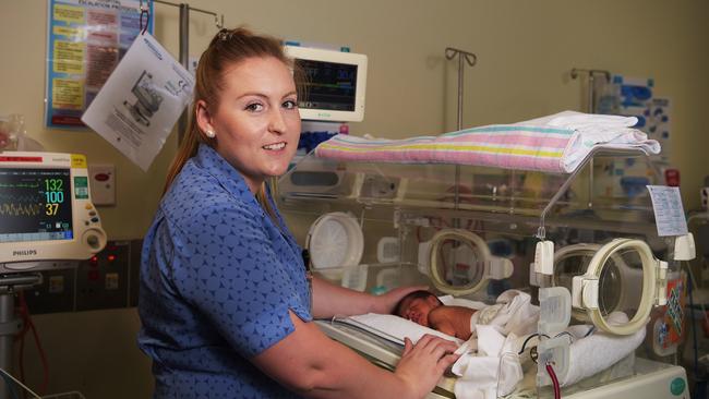 Midwife Jemima Hart comforts baby Flynn Beck, seven days old, who was eight weeks early while he sleeps inside the neonatal intensive care unit at the Jabiru (Maternity Ward) Darwin Private Hospital. Picture: Keri Megelus