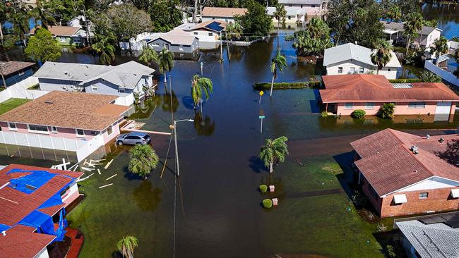 TOPSHOT - Neighborhoods are inundated in the aftermath of Hurricane Milton in Lake Maggiore, Florida, on October 10, 2024. At least 10 people were dead after Hurricane Milton smashed into Florida, US authorities said, after the monster weather system sent tornados spinning across the state and flooded swaths of the Tampa Bay area. (Photo by Miguel J. Rodriguez Carrillo / AFP)