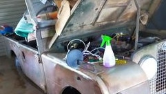 Mr O'Sullivan senior and junior's mobile phone charging invention through an old jeep's battery, in Brushgrove in the 2022 floods.