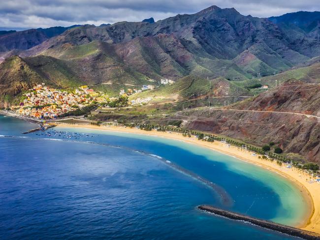 view of the coast of the paradise island of Tenerife with crystal clear and turquoise water and blue sky with drone. Teresitas beach