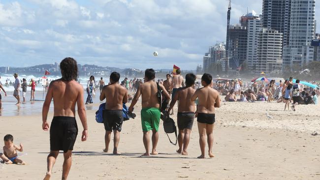 A group of Burmese men walk to the flagged area. Picture: Glenn Hampson