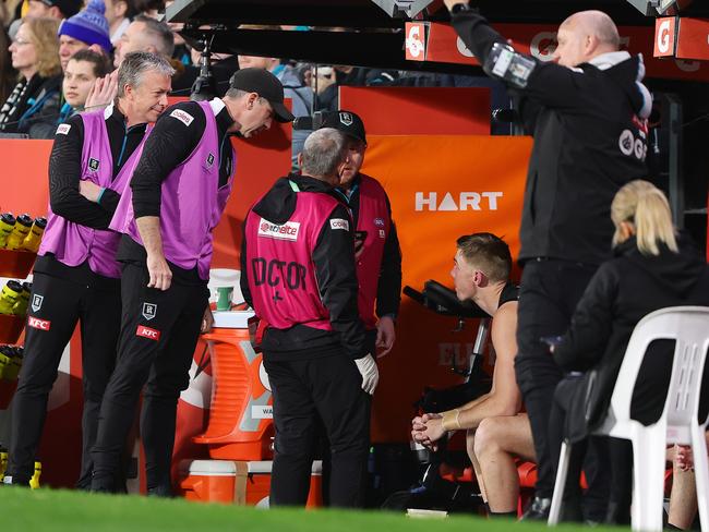 Todd Marshall talks with Port Adelaide’s doctors on Friday night. Picture: Sarah Reed/AFL Photos