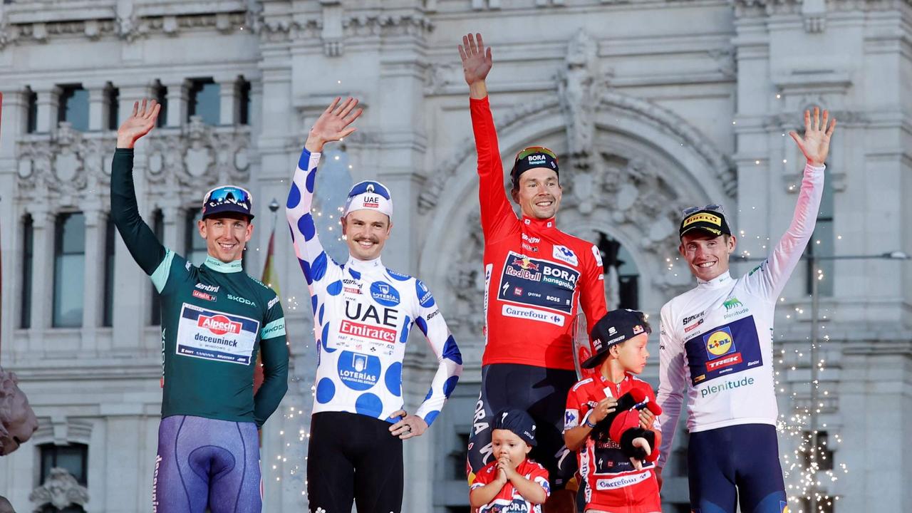 Kaden Groves, Jay Vine, Primoz Roglic and Mattias Skjelmose celebrate on the podium after the last stage of the Vuelta a Espana. Picture: Oscar Del Pozo / AFP