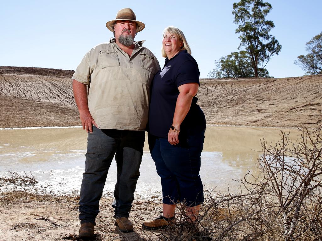 Farmers Richard and Diane Darcy at one of their many empty dams on their farm in Tullamore. Picture: Jonathan Ng