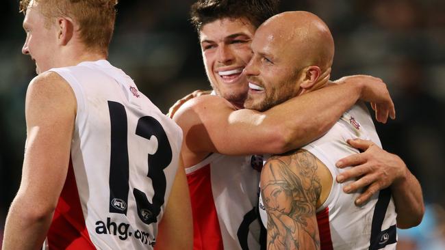 Clayton Oliver and Angus Bradshaw are all smiles after a Nathan Jones goal. Picture: AAP