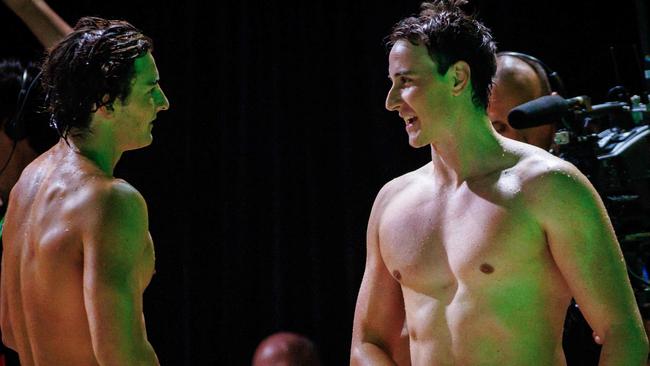 Cam McEvoy (R) speaks with compatriot Armbruster (L) after g the men’s 50m freestyle final. Picture: Patrick HAMILTON / AFP